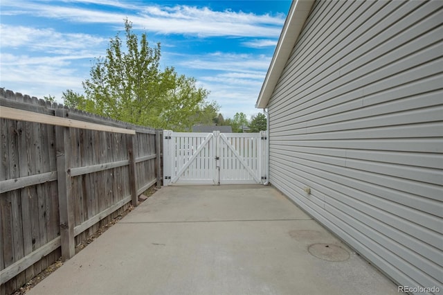 view of patio with a gate and fence