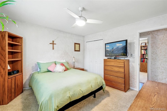 bedroom with ceiling fan, a closet, and carpet flooring