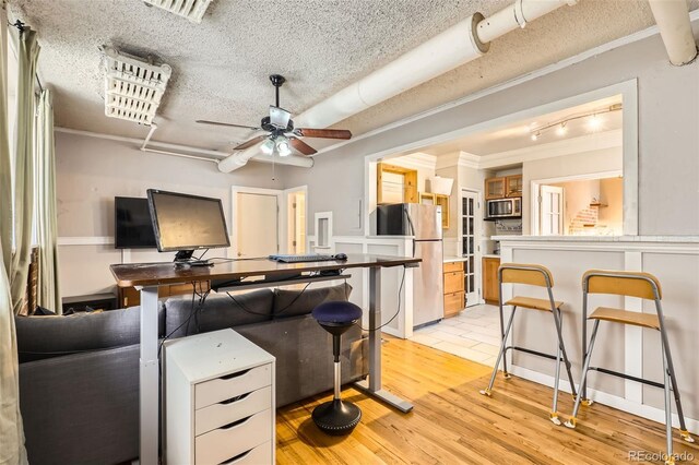 1376 N Pearl St Unit B1, Denver, CO 80203 - living area featuring visible vents, a ceiling fan, ornamental molding, light wood-style floors, and a textured ceiling