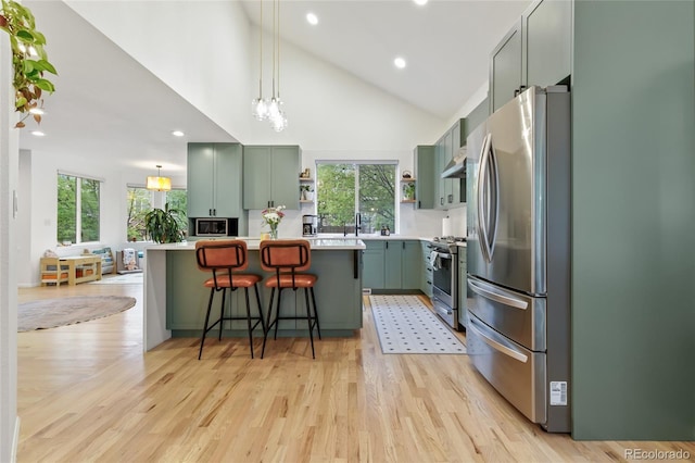 1540 Meachum Way, Erie, CO 80516 - kitchen with stainless steel appliances, green cabinets, open shelves, light countertops, and recessed lighting