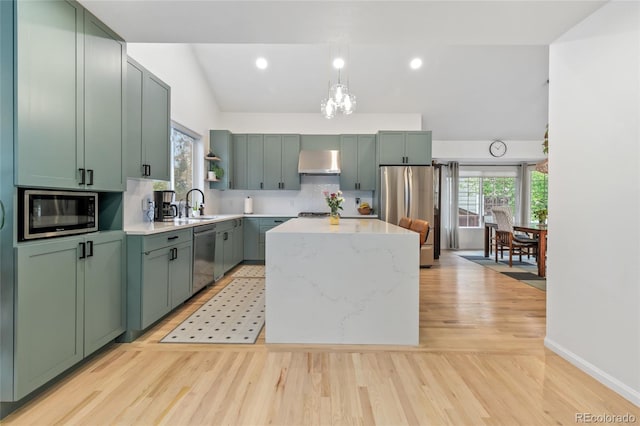 1540 Meachum Way, Erie, CO 80516 - kitchen with stainless steel appliances, ventilation hood, a kitchen island, a sink, and open shelves
