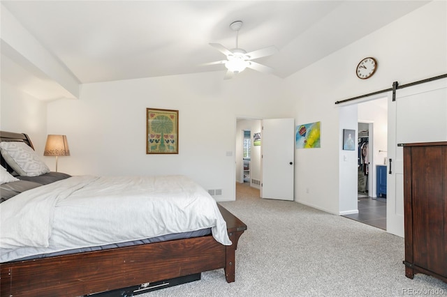 1540 Meachum Way, Erie, CO 80516 - carpeted bedroom featuring a barn door, a walk in closet, lofted ceiling, ceiling fan, and a closet
