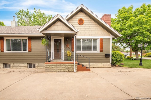 3317 Harlan St, Wheat Ridge, CO 80033 - view of front of property featuring a chimney, a shingled roof, and a patio area