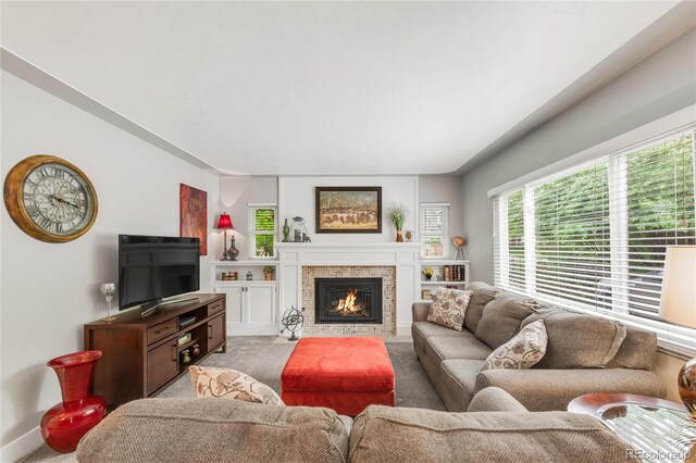 3317 Harlan St, Wheat Ridge, CO 80033 - living room featuring light colored carpet and a tiled fireplace