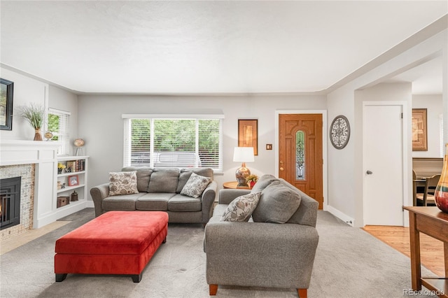 3317 Harlan St, Wheat Ridge, CO 80033 - living area with a fireplace, light colored carpet, and baseboards