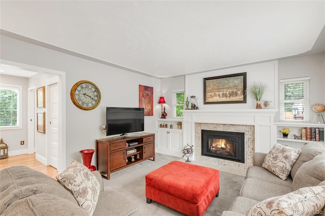 3317 Harlan St, Wheat Ridge, CO 80033 - living area featuring a tiled fireplace and baseboards