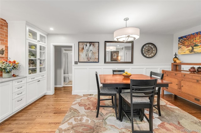 3317 Harlan St, Wheat Ridge, CO 80033 - dining area featuring light wood-style floors, a wainscoted wall, and recessed lighting