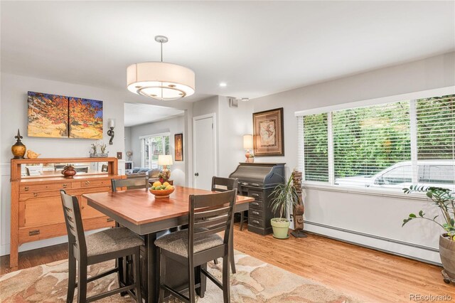 3317 Harlan St, Wheat Ridge, CO 80033 - dining space with a baseboard heating unit and light wood finished floors