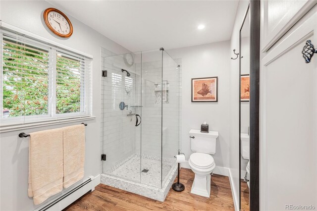 3317 Harlan St, Wheat Ridge, CO 80033 - bathroom featuring toilet, wood finished floors, a baseboard heating unit, a stall shower, and recessed lighting