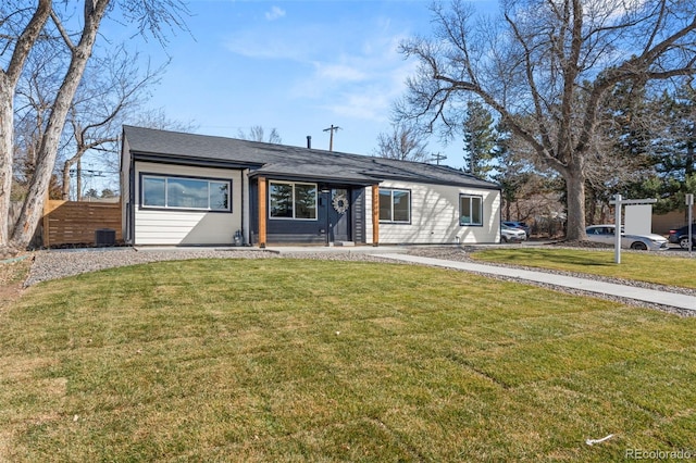 view of front of house featuring cooling unit, a front yard, and fence