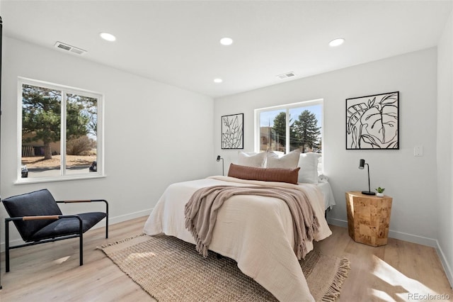 bedroom featuring visible vents, recessed lighting, light wood-type flooring, and baseboards