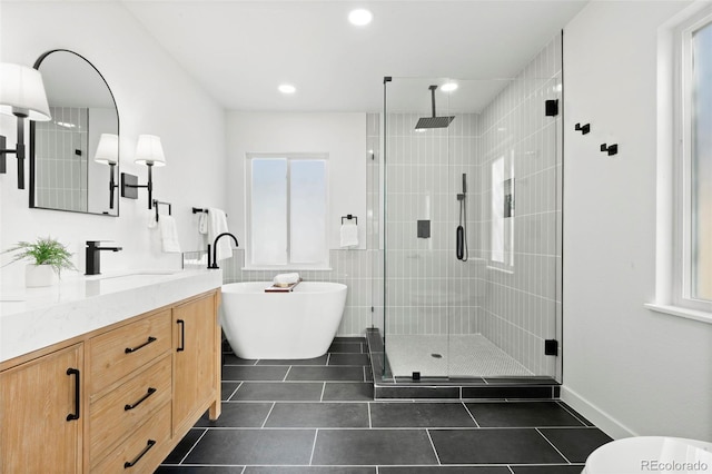 full bath featuring tile patterned floors, a soaking tub, a shower stall, and vanity