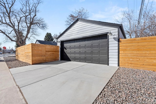 detached garage featuring fence