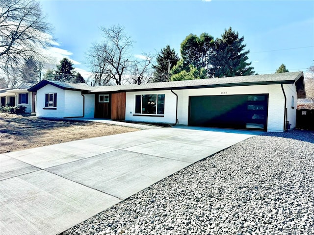 ranch-style home featuring driveway and an attached garage