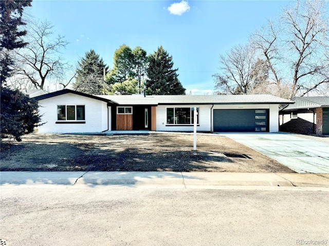 view of front of house featuring a garage and concrete driveway