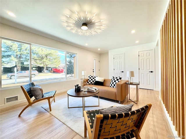 living area featuring a chandelier, recessed lighting, visible vents, baseboards, and light wood-style floors