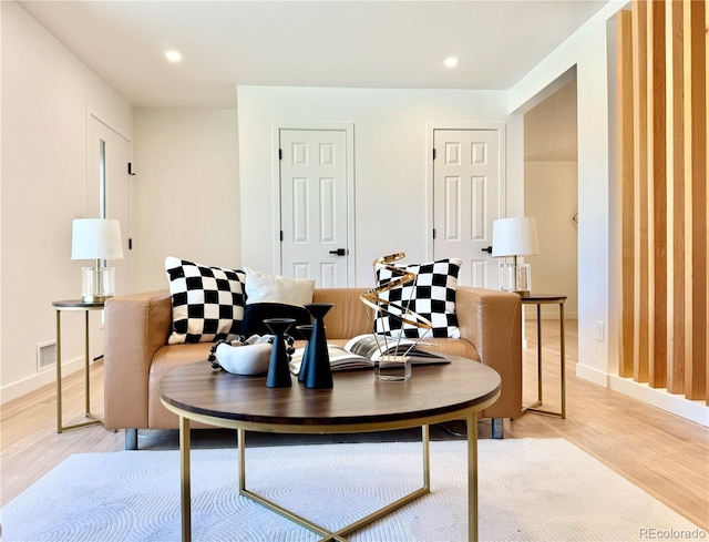 interior space featuring light wood-type flooring, baseboards, and recessed lighting