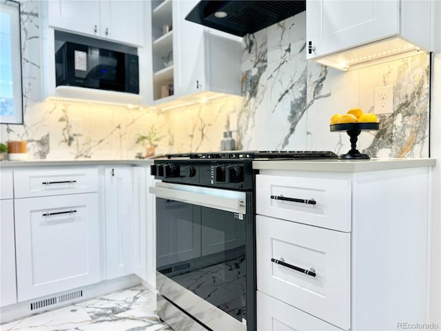 kitchen featuring black microwave, exhaust hood, white cabinets, and range with gas stovetop