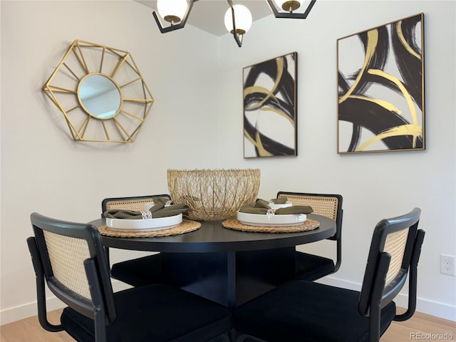 dining area featuring light wood-type flooring and baseboards