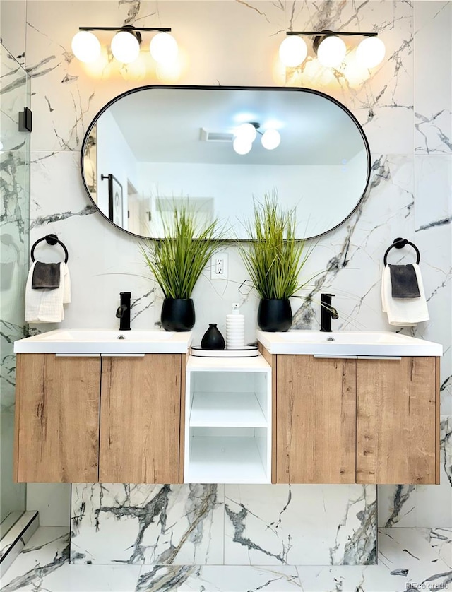 interior space with a baseboard heating unit, marble finish floor, a sink, and stone wall