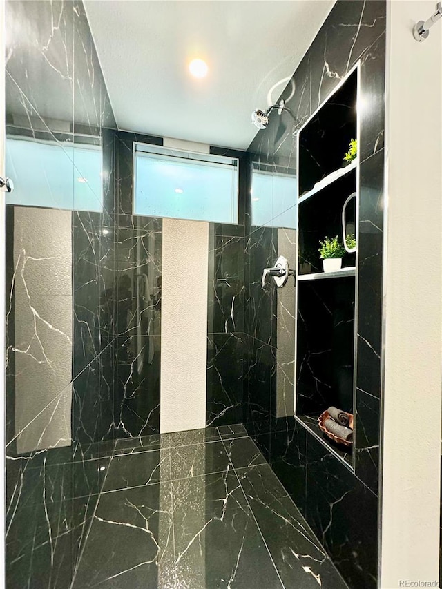 full bath featuring marble finish floor and a marble finish shower