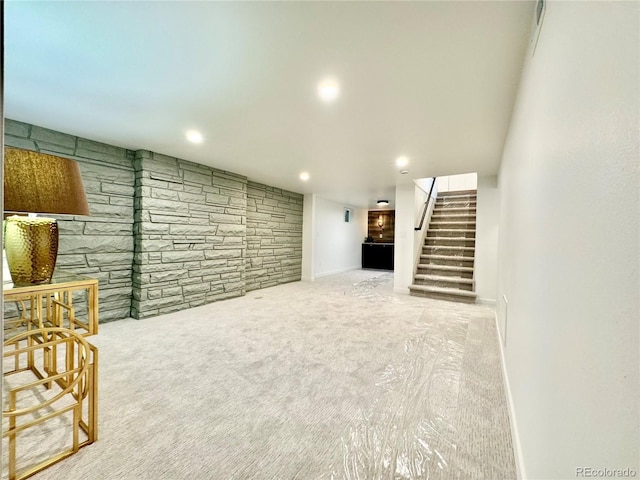 finished basement with light carpet, stairway, recessed lighting, and baseboards