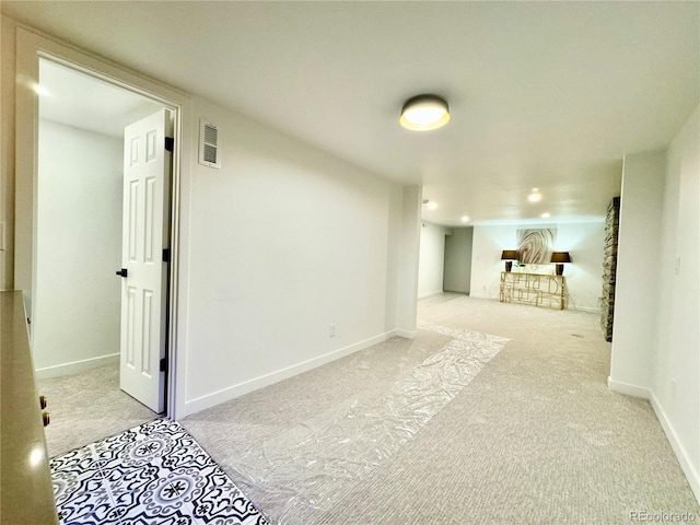 finished below grade area with recessed lighting, visible vents, light carpet, and baseboards