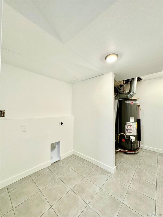 clothes washing area featuring laundry area, light tile patterned floors, baseboards, hookup for an electric dryer, and gas water heater