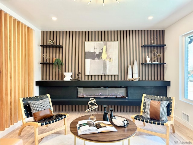 sitting room featuring wood finished floors, visible vents, and recessed lighting