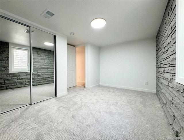 unfurnished bedroom with visible vents, baseboards, carpet flooring, and a closet