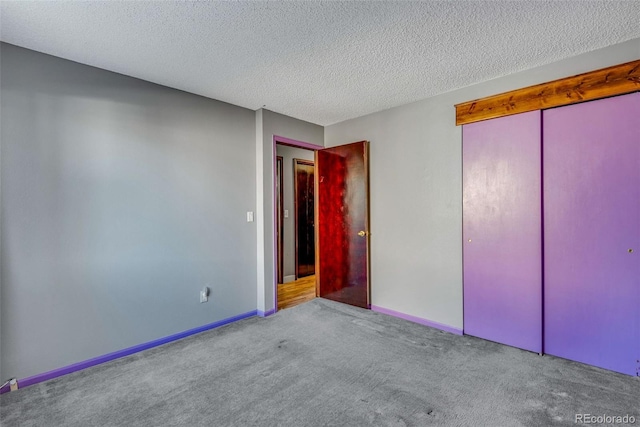 unfurnished bedroom with a closet, light colored carpet, and a textured ceiling