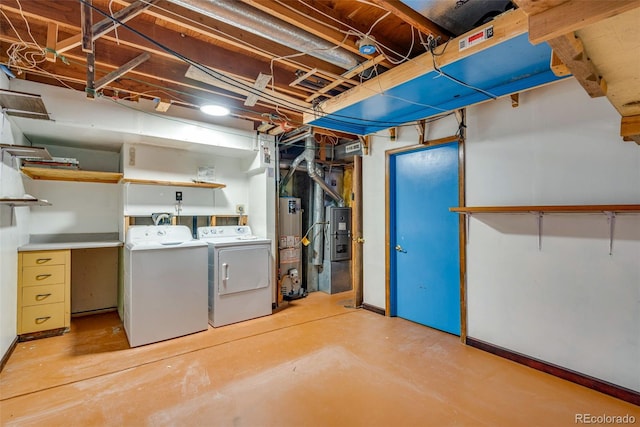 basement featuring washing machine and dryer and water heater