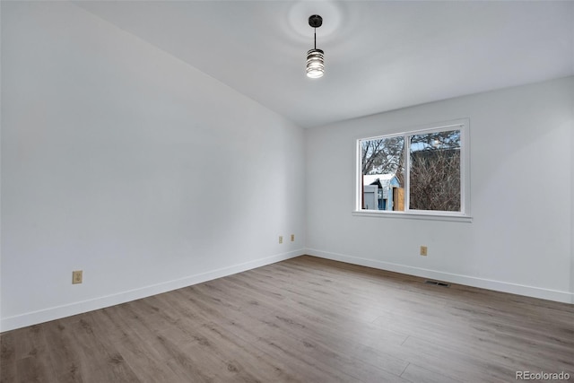 unfurnished room with wood-type flooring