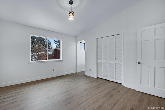 unfurnished bedroom with light hardwood / wood-style floors and a closet