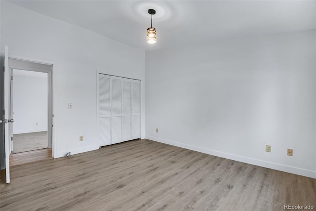 unfurnished bedroom with a closet and light hardwood / wood-style flooring