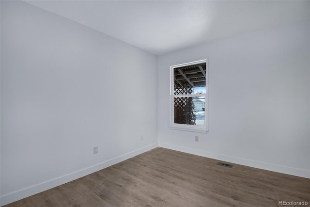 empty room with hardwood / wood-style flooring