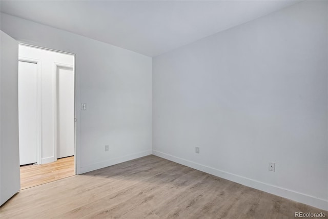 unfurnished room with light wood-type flooring