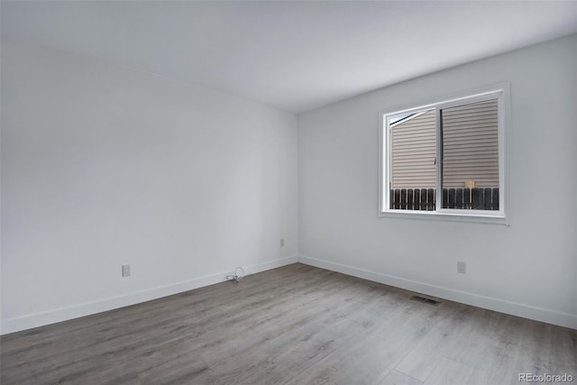 spare room featuring light hardwood / wood-style floors