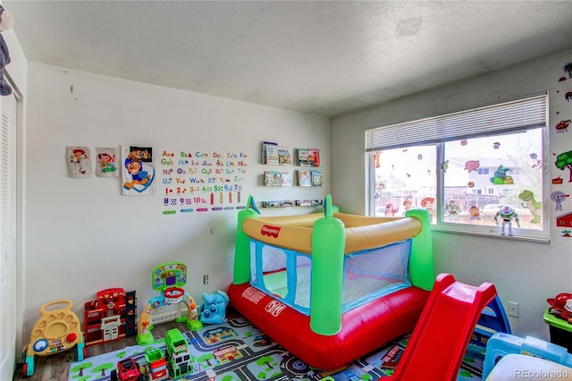 game room with a textured ceiling