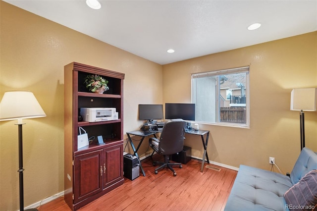 office area featuring baseboards, light wood finished floors, and recessed lighting