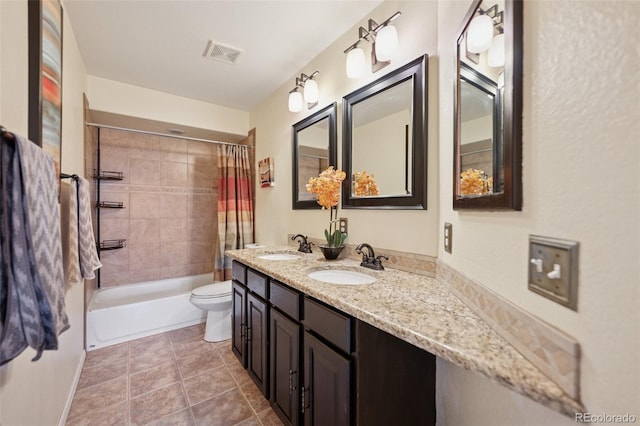 bathroom featuring visible vents, toilet, tile patterned floors, a sink, and shower / tub combo with curtain