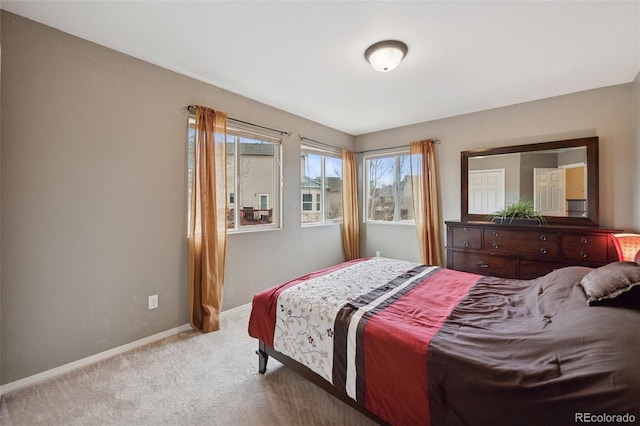 bedroom with baseboards and carpet