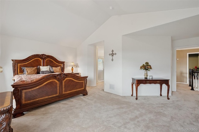 carpeted bedroom featuring vaulted ceiling and visible vents