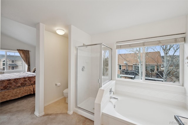bathroom featuring a stall shower, baseboards, toilet, and a garden tub