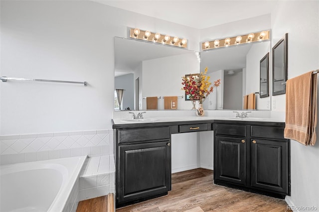 4013 Pronghorn Meadows Cir, Colorado Springs, CO 80922 - full bathroom featuring double vanity, a bath, and wood finished floors