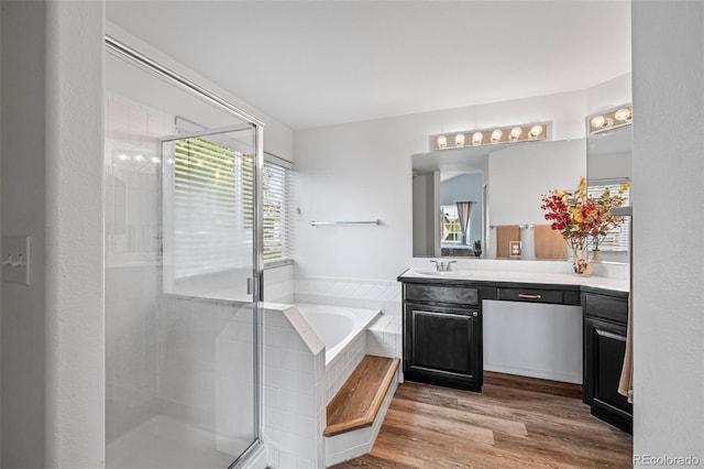4013 Pronghorn Meadows Cir, Colorado Springs, CO 80922 - full bathroom with vanity, a bath, a shower stall, and wood finished floors