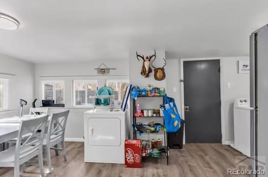 1317 Bragdon Ave, Pueblo, CO 81004 - laundry room featuring washer / clothes dryer and wood finished floors