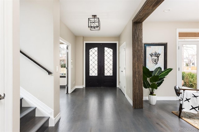 entryway with stairs, french doors, dark wood-style flooring, and baseboards