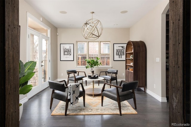 dining area with baseboards, arched walkways, dark wood-style flooring, french doors, and a chandelier