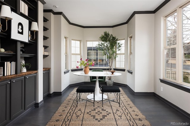 dining area with dark wood-style floors, baseboards, and ornamental molding